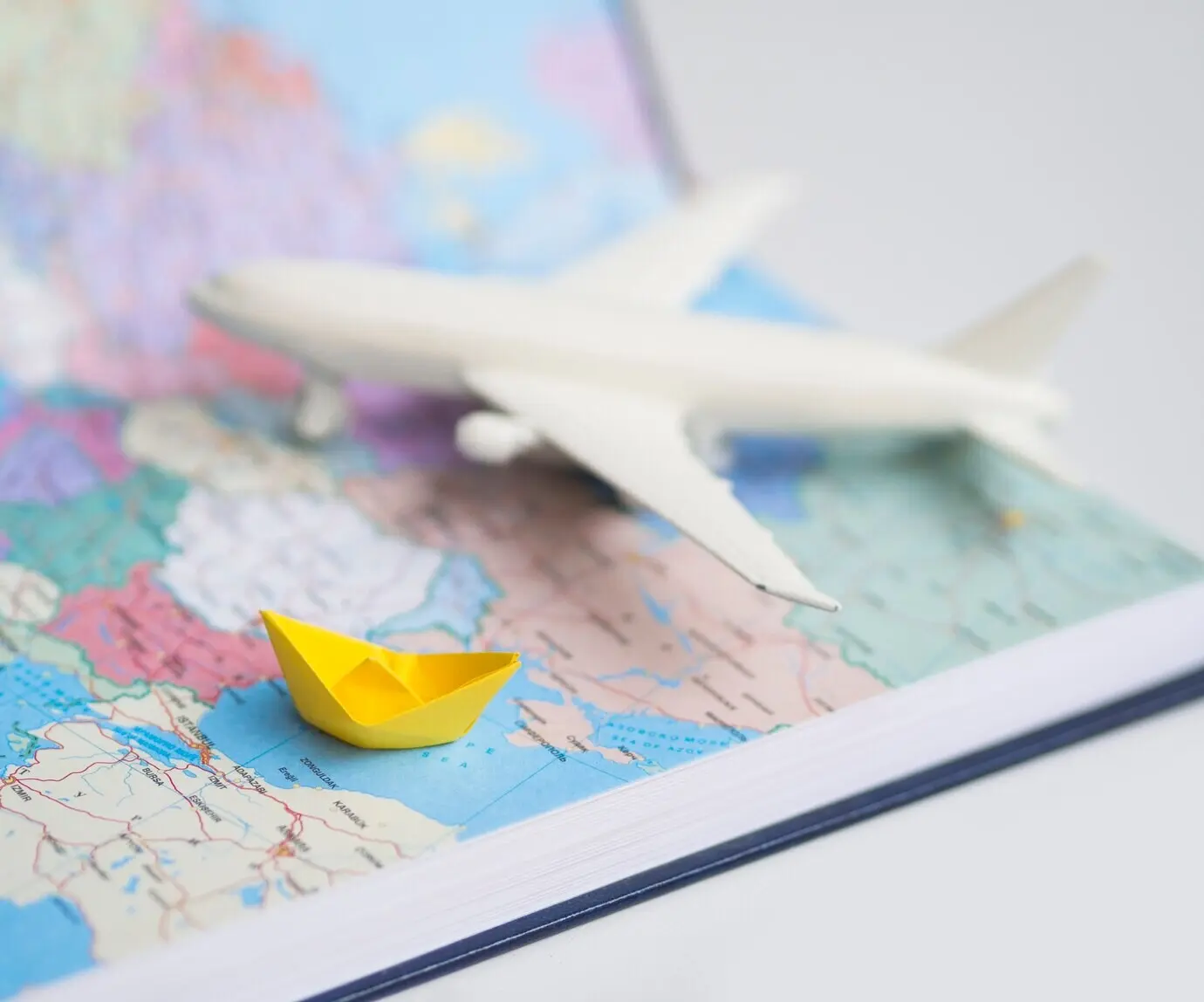 A world map featuring a blurred airplane.
